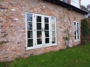 Greasby Wirral. New Evolution Storm 2 French doors sprayed to a bespoke Ral colour . The door features Wroght Iron Handles 